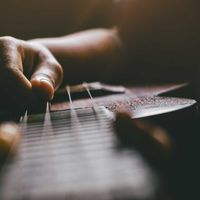 hands-playing-acoustic-ukulele-guitar-music-skills-show