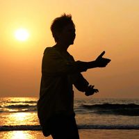 silhouette-active-senior-woman-practicing-tai-chi-gymnastic-sandy-beach-sunset